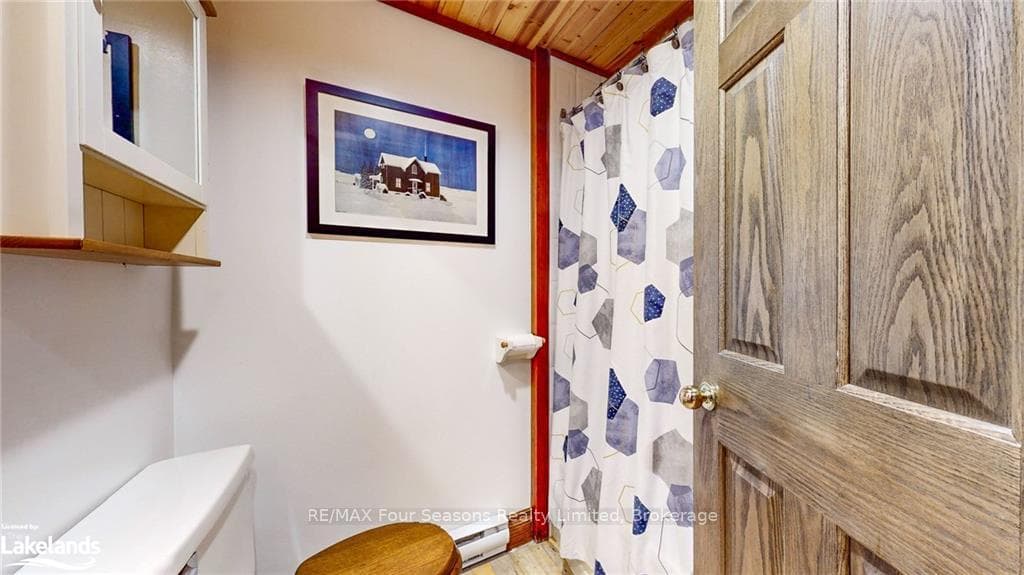 Bathroom with wooden ceiling, wood-type flooring,