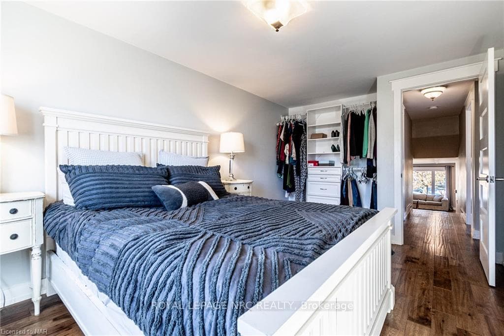Bedroom with dark hardwood / wood-style flooring a