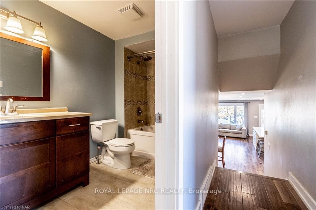 Full bathroom featuring hardwood / wood-style floo