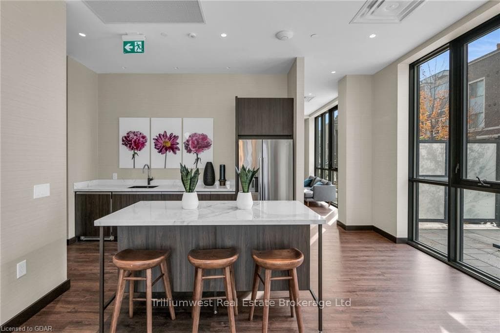 Kitchen featuring stainless steel fridge with ice