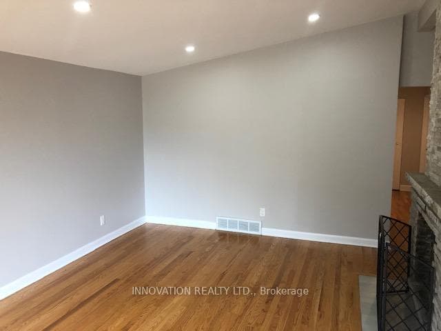 Main floor living room with dual sided fireplace