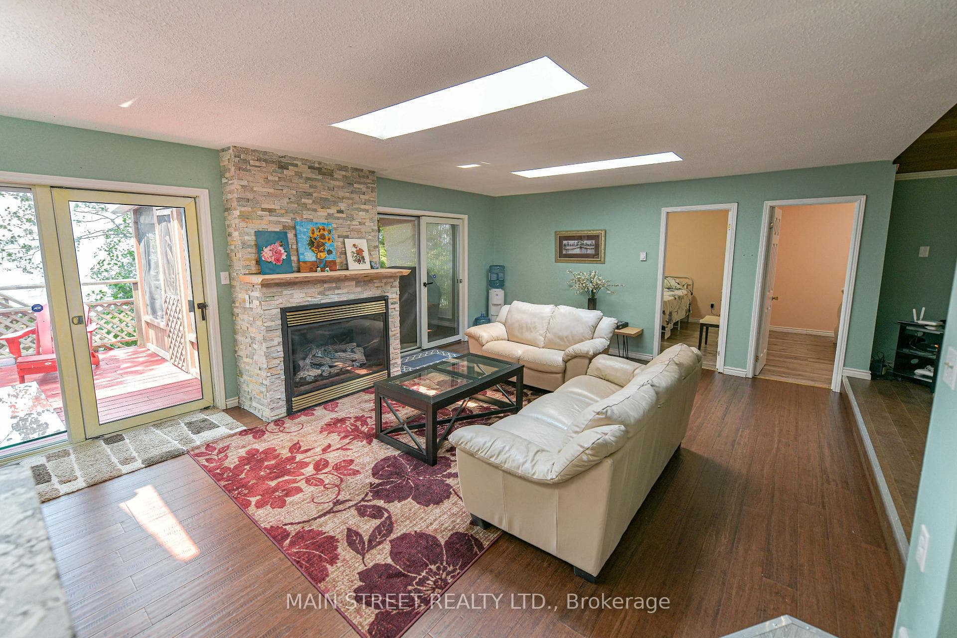 Living Room Featuring Fireplace and 3 Skylights