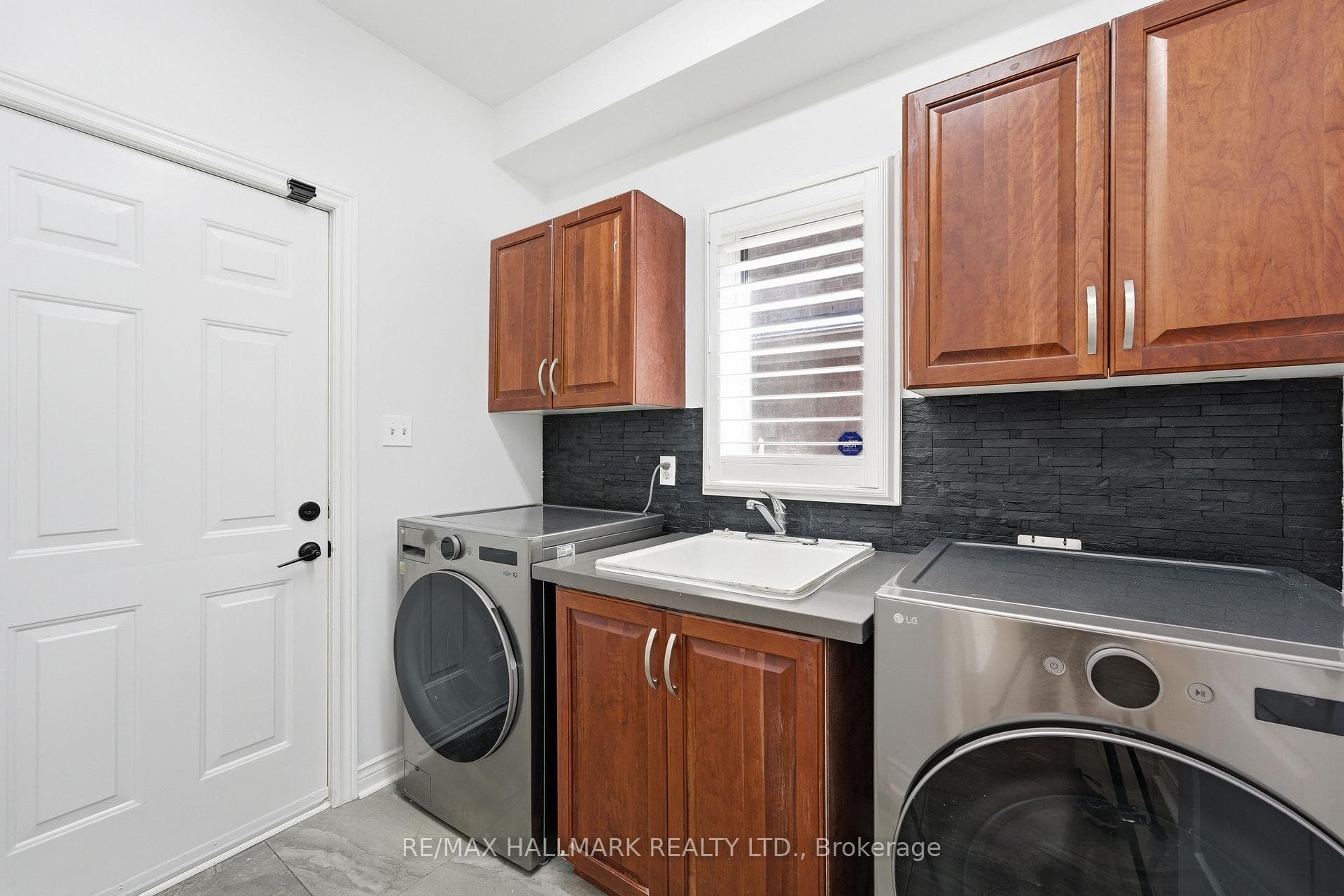 Full Laundry Room with Washer/Dryer and Sink