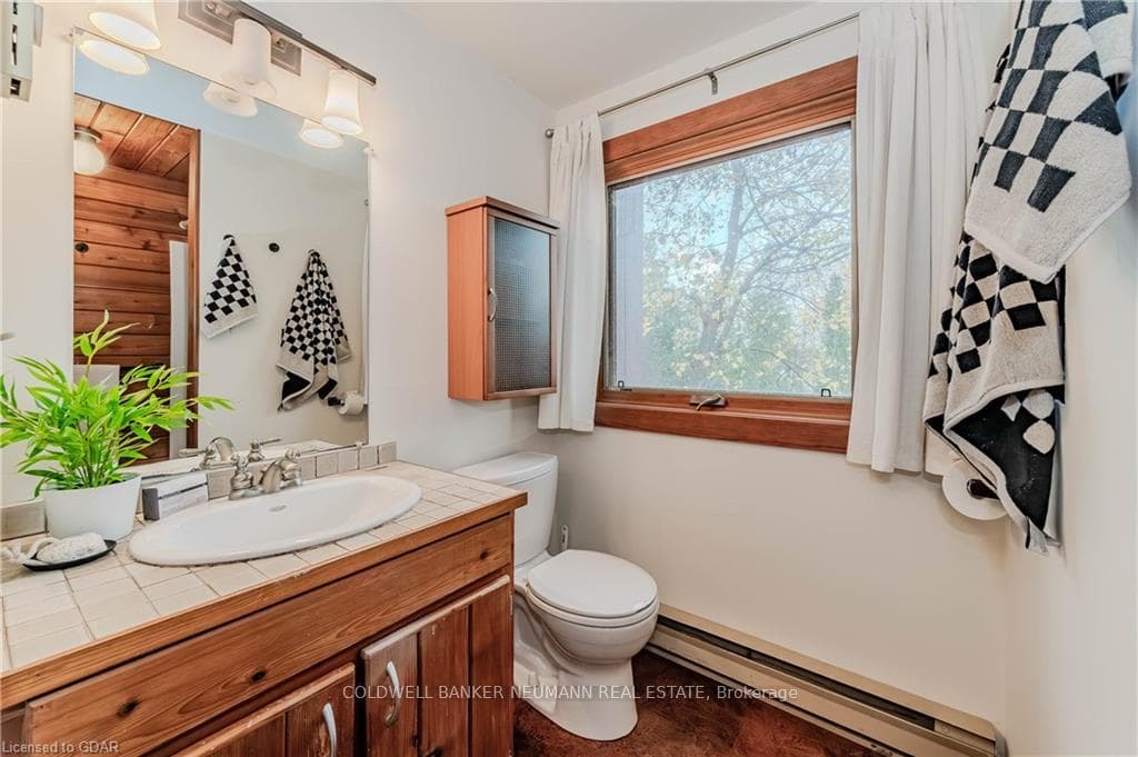 Bathroom with vanity, toilet, basemoard heating