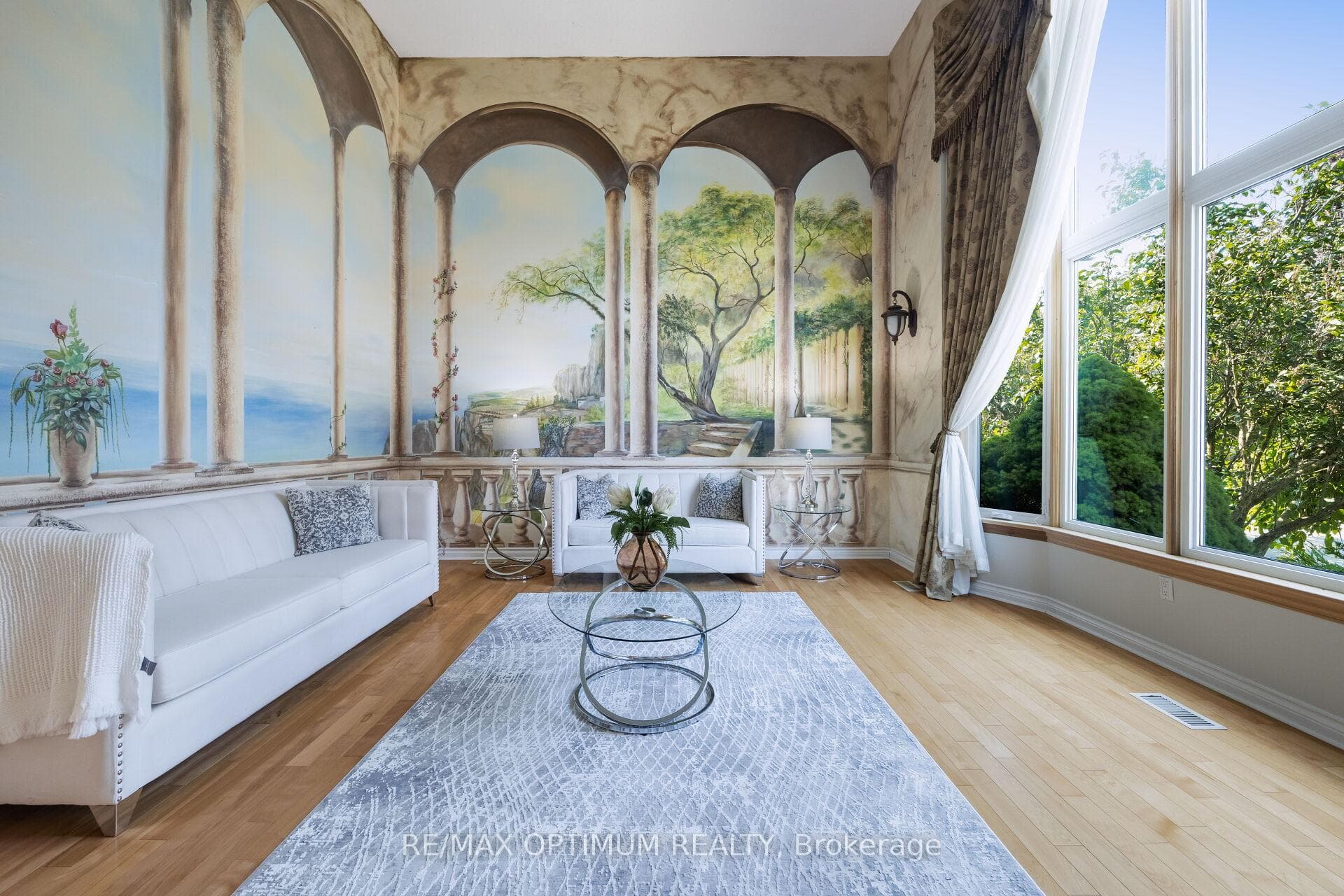 Sun-filled formal living with soaring windows
