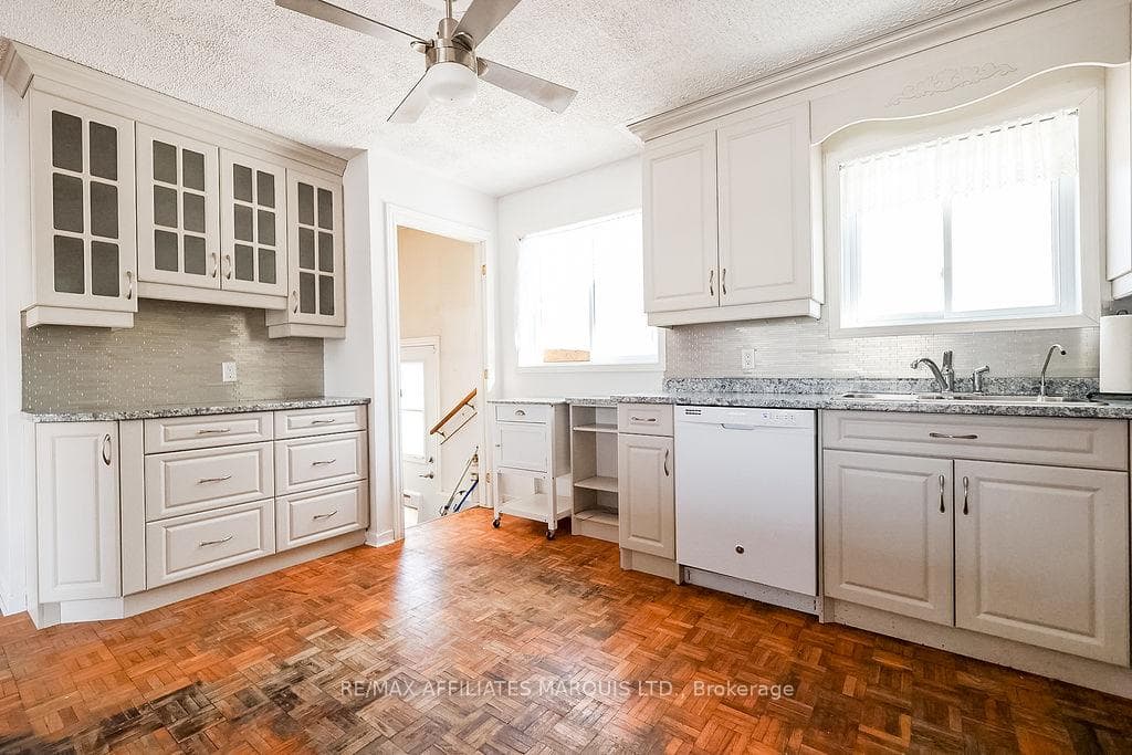 Kitchen showing back entrance & stairs to basement