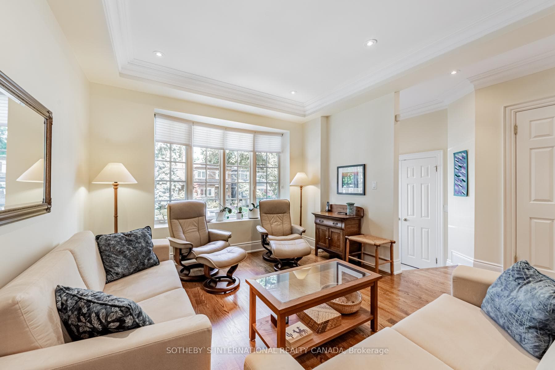 Sunlit living room with bow window charm