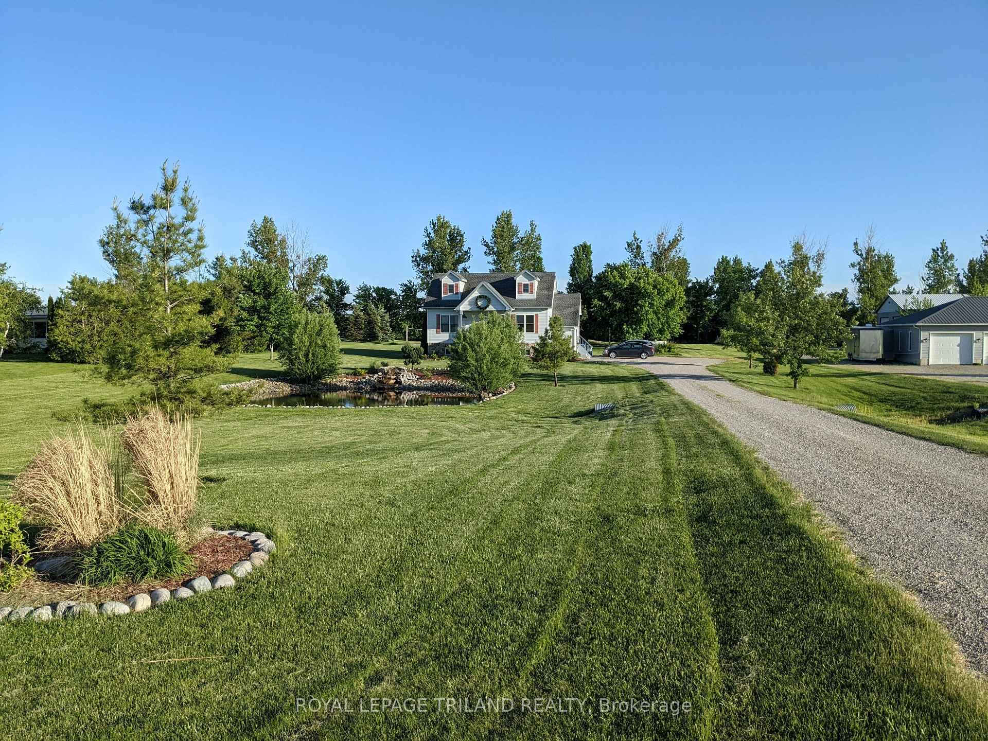 Grand entrance with a long, private driveway