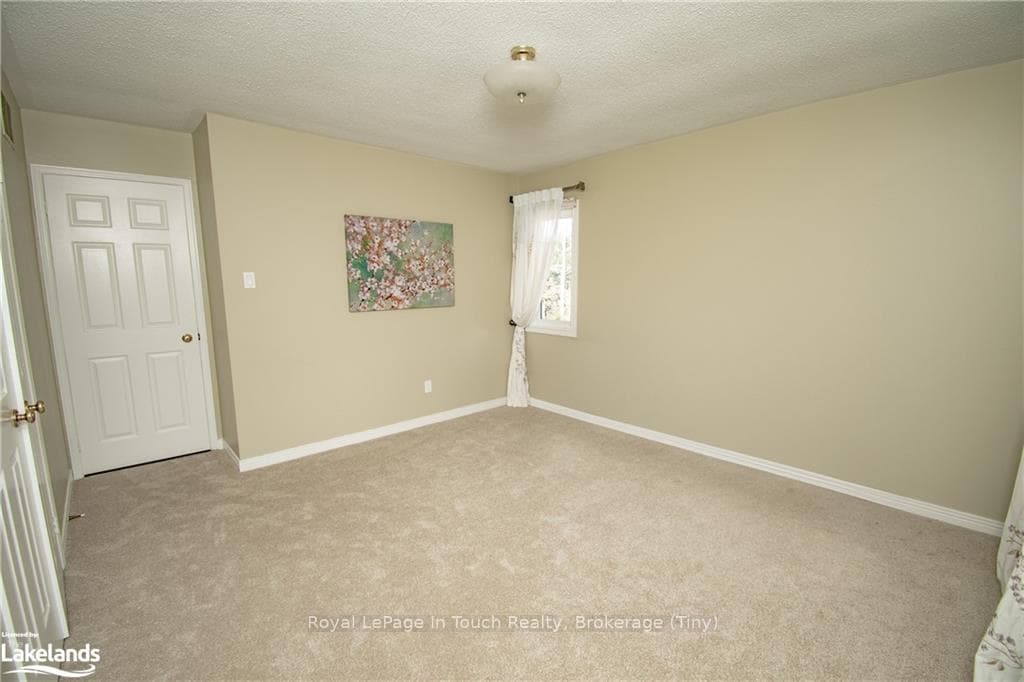 Unfurnished room with a textured ceiling and light