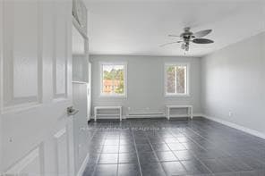 Empty room with fan ,patterned floors baseboar