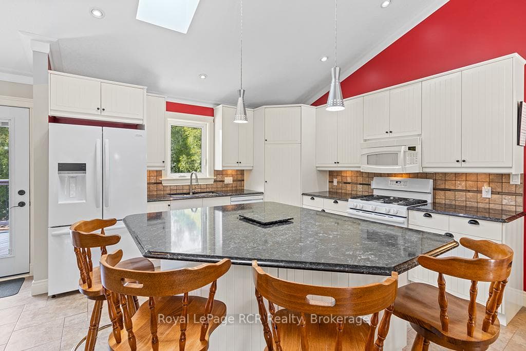 Modern open kitchen with island & walk-in pantry.