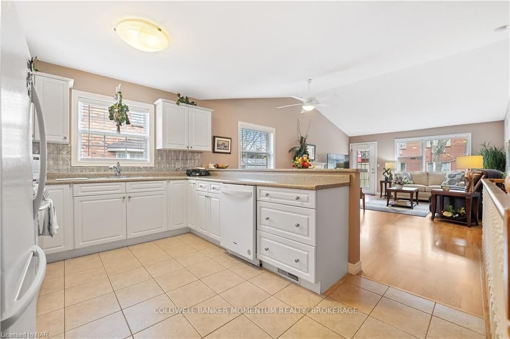 Bright kitchen with white cabinetry and appliances