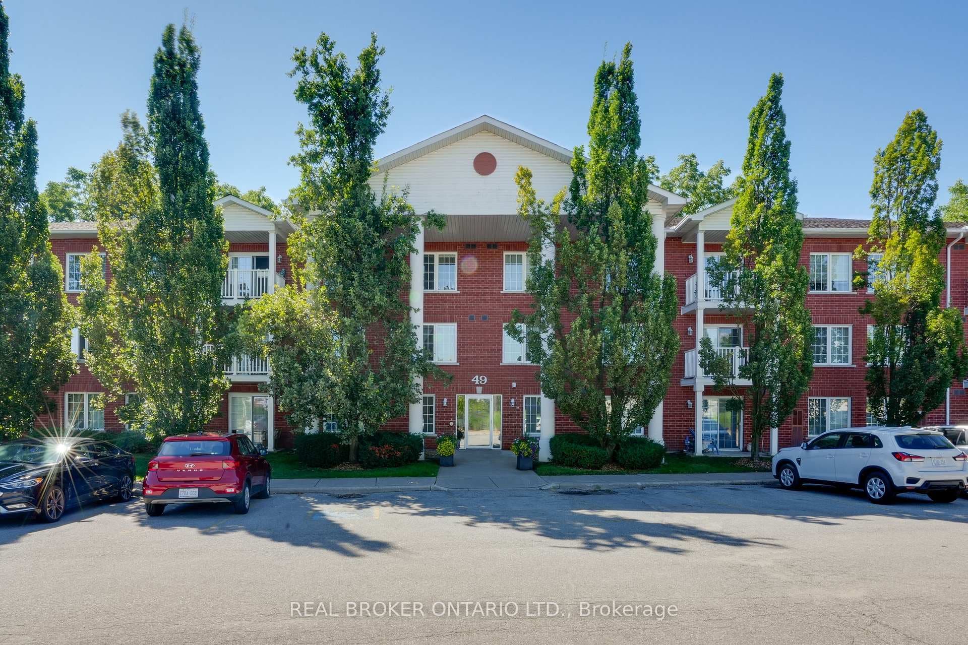 Exterior Building, mature trees, visitor parking
