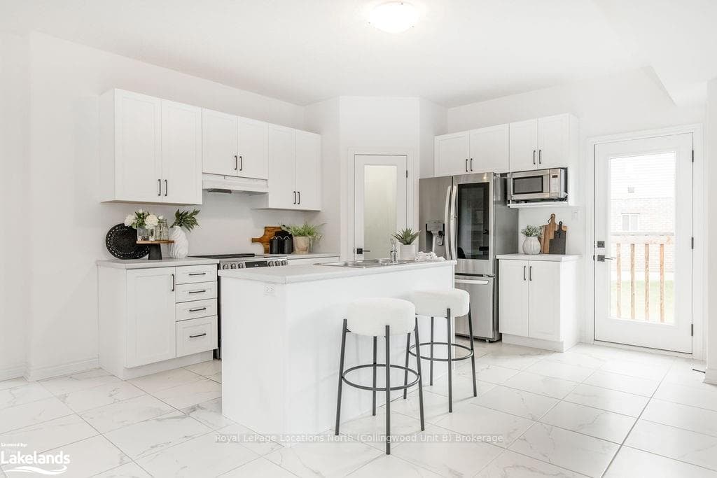 Kitchen featuring an island with sink, a kitchen b