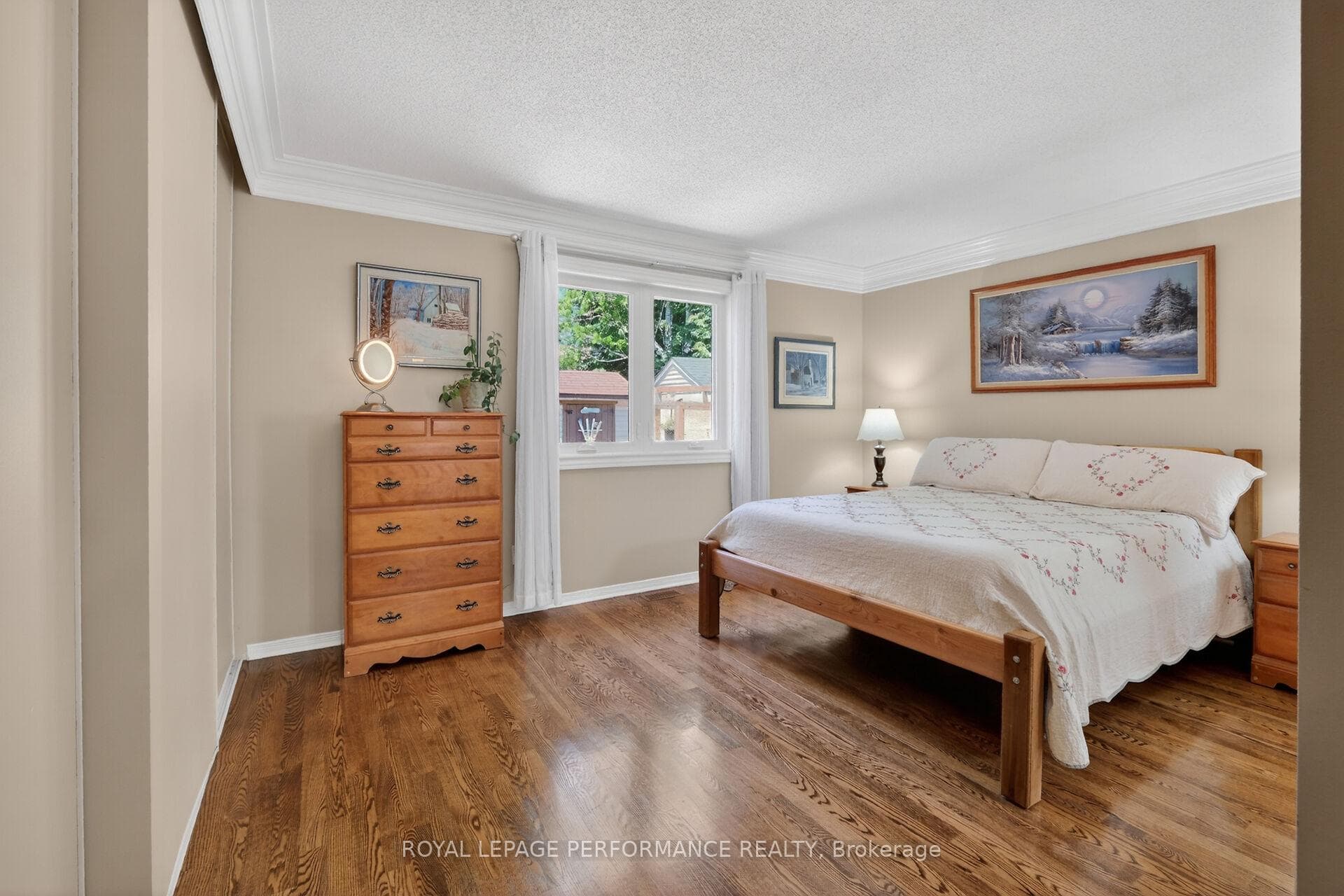 Primary bedroom with peaceful backyard views