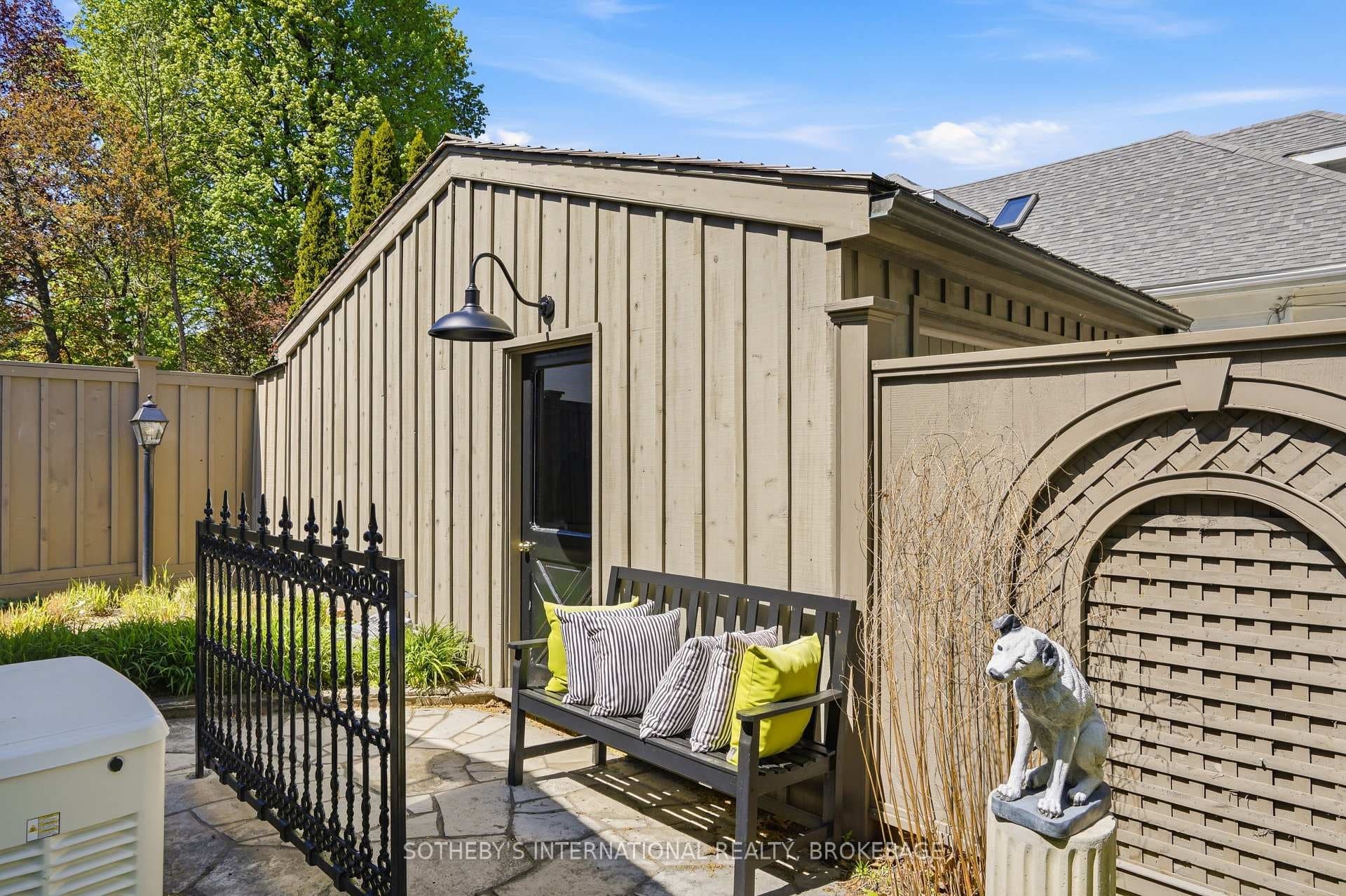 Side entrance to detached garage and tool shed.