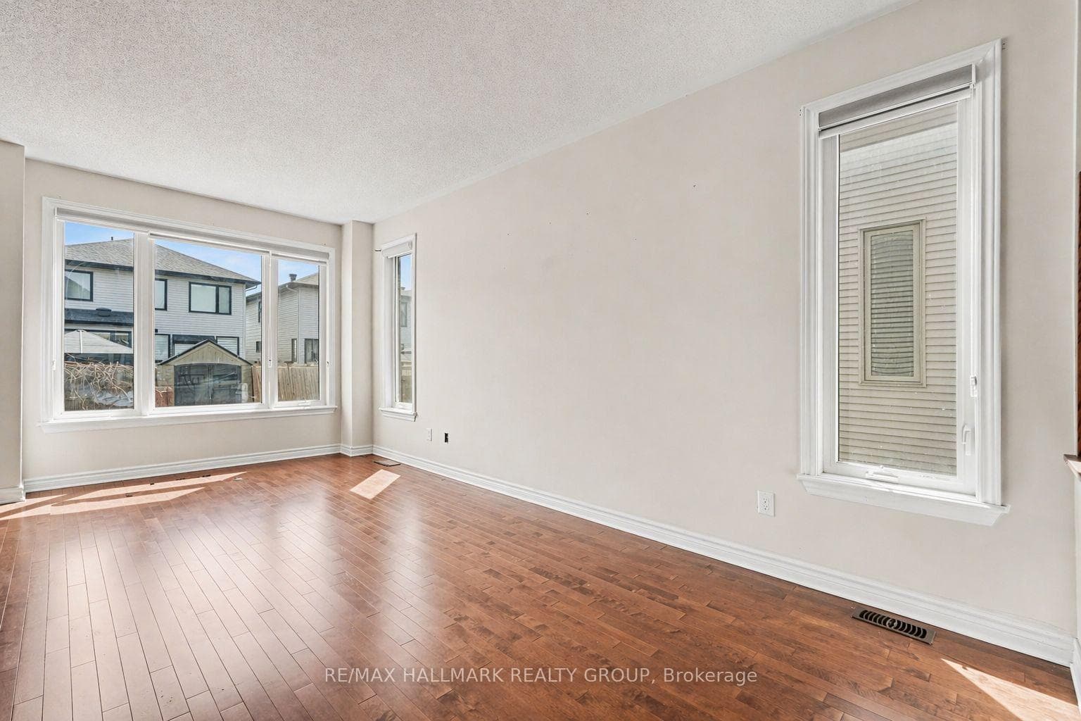 Living room with large window to backyard