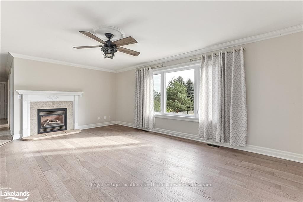Unfurnished living room featuring light hardwood /
