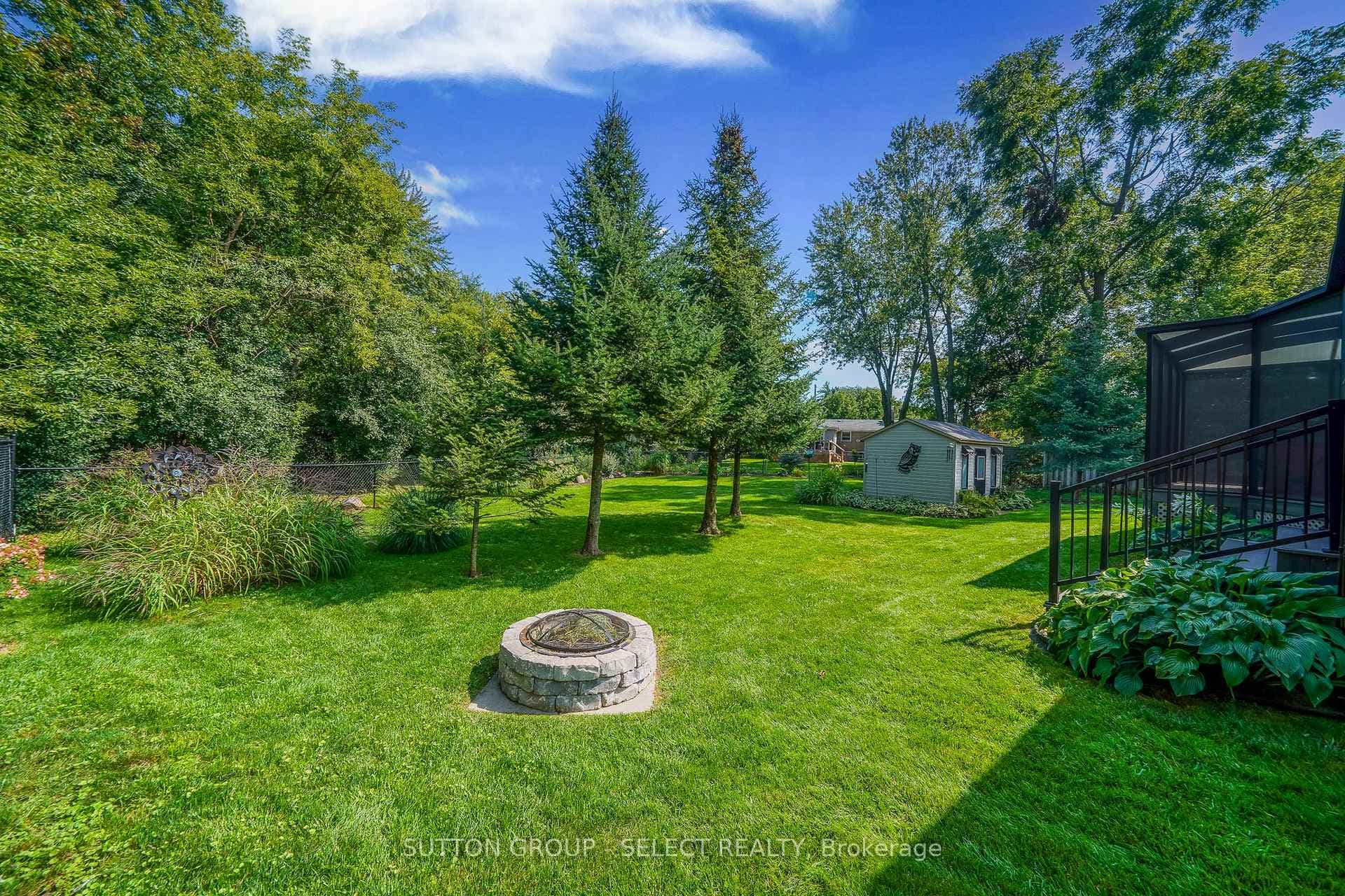 Custom stone firepit & mature trees throughout