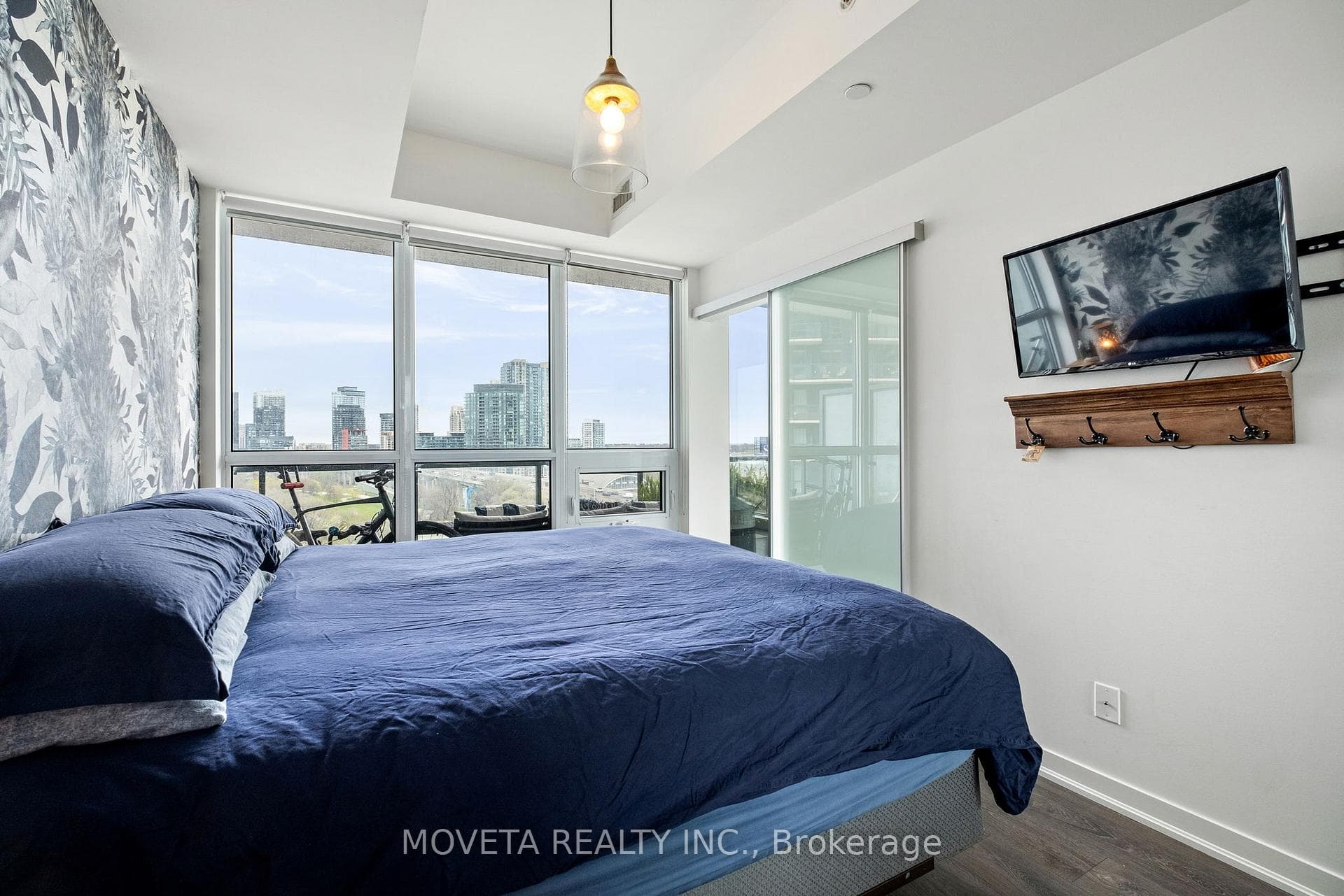 Primary Bedroom Overlooking Balcony and City
