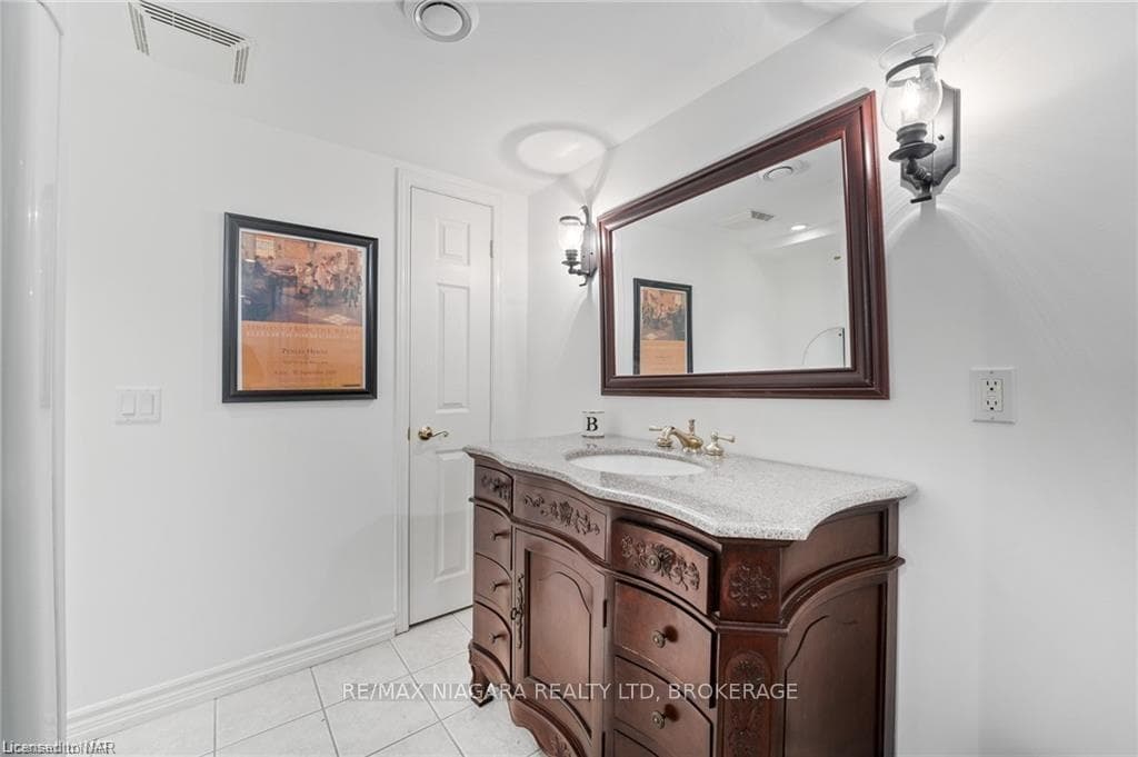 Bathroom featuring tile patterned flooring and van