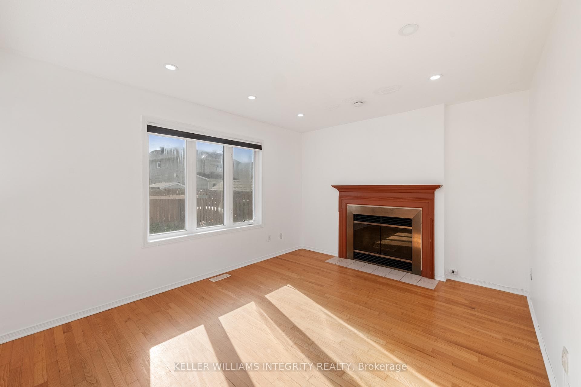 Bright family room with wood burning fireplace
