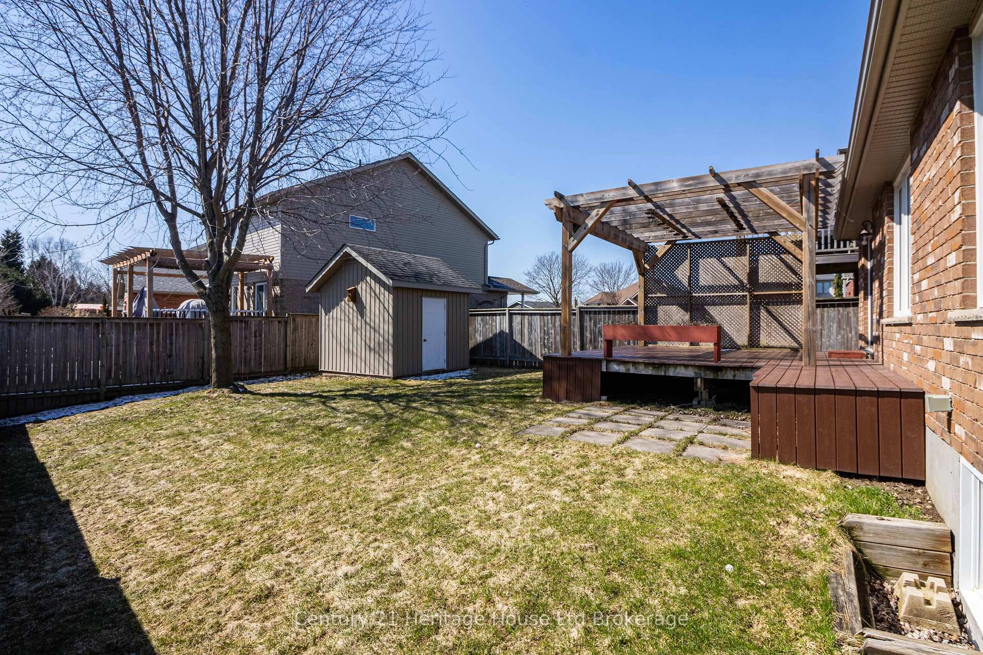 private backyard with deck and garden shed