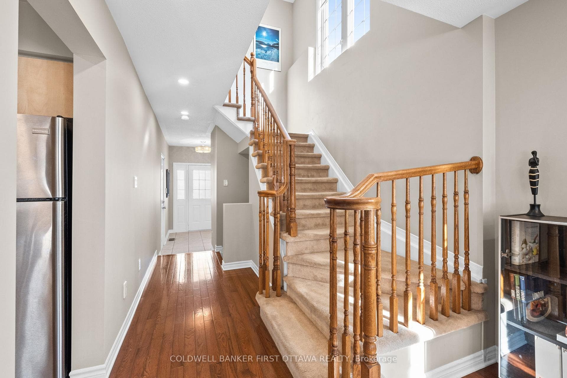 Stairs up to second level w vertical window.
