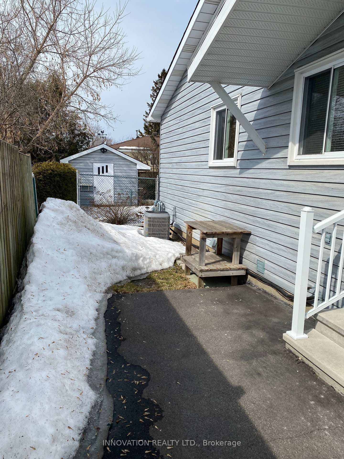 side entrance and view of shed in back yard
