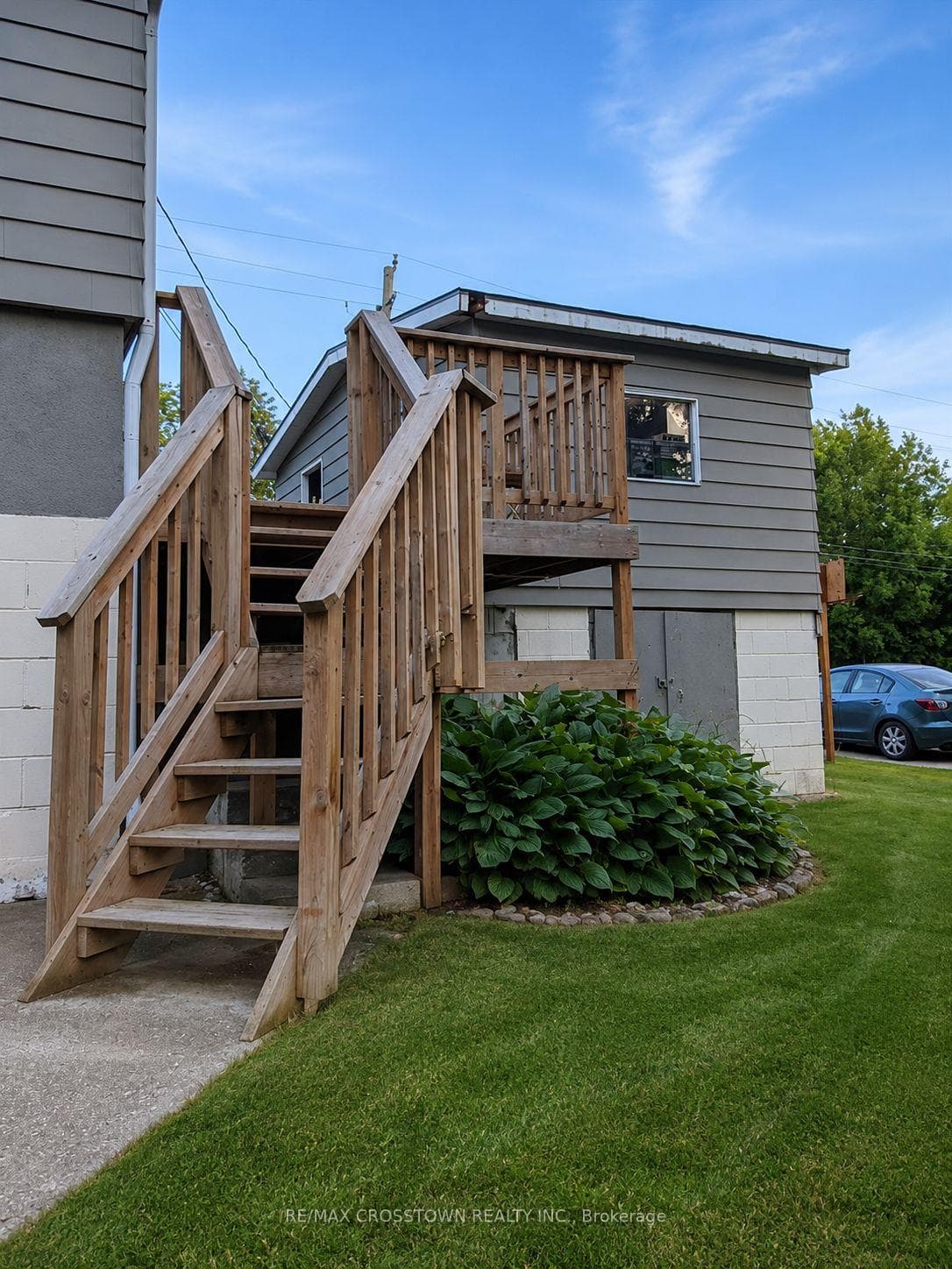 Stairs down to the front door from the driveway.