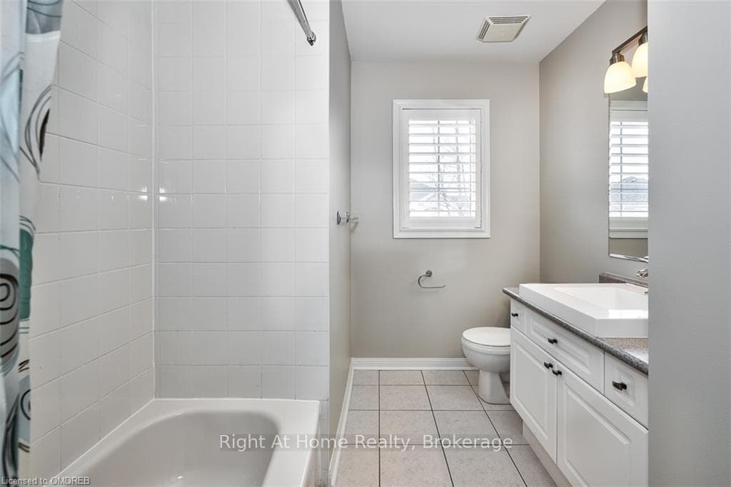 Full bathroom featuring toilet, vanity, shower / b