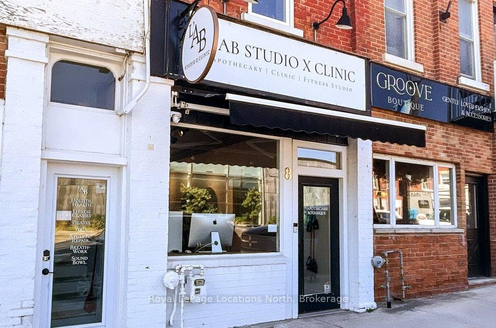 Store front with exterior lighting and awning.