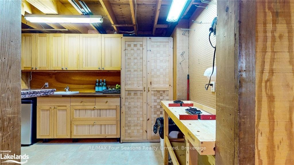 Kitchen with light brown cabinetry and sink