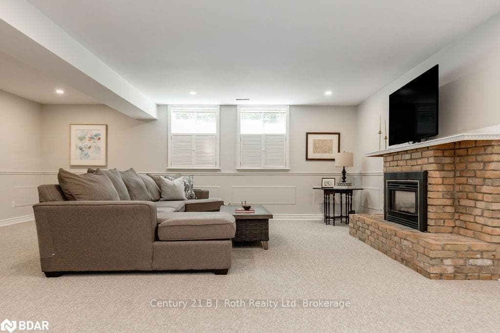 Living room featuring a fireplace and light carpet
