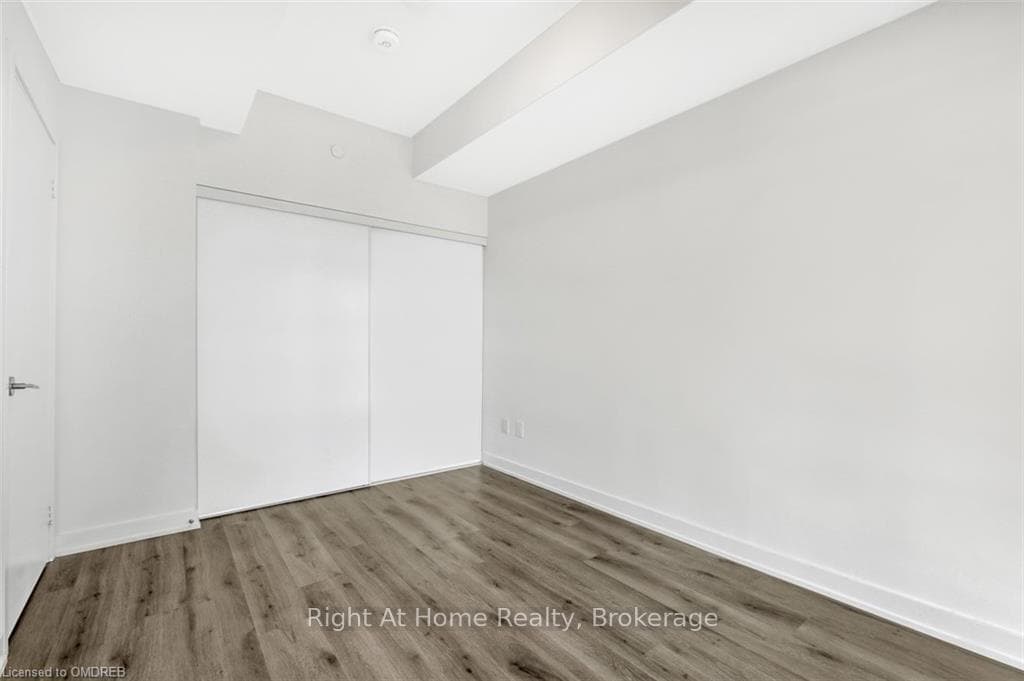 Unfurnished bedroom featuring a closet and hardwoo