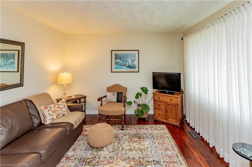 Living room with dark hardwood / wood-style floori