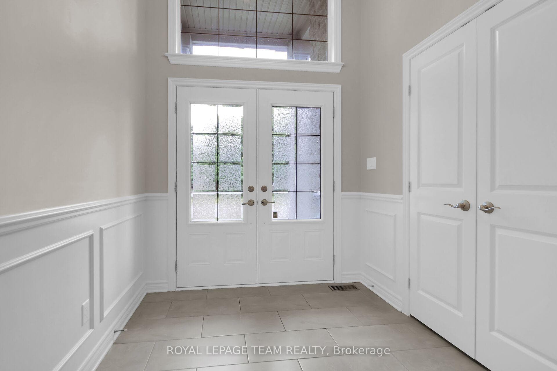 Double door front entrance and huge transom window