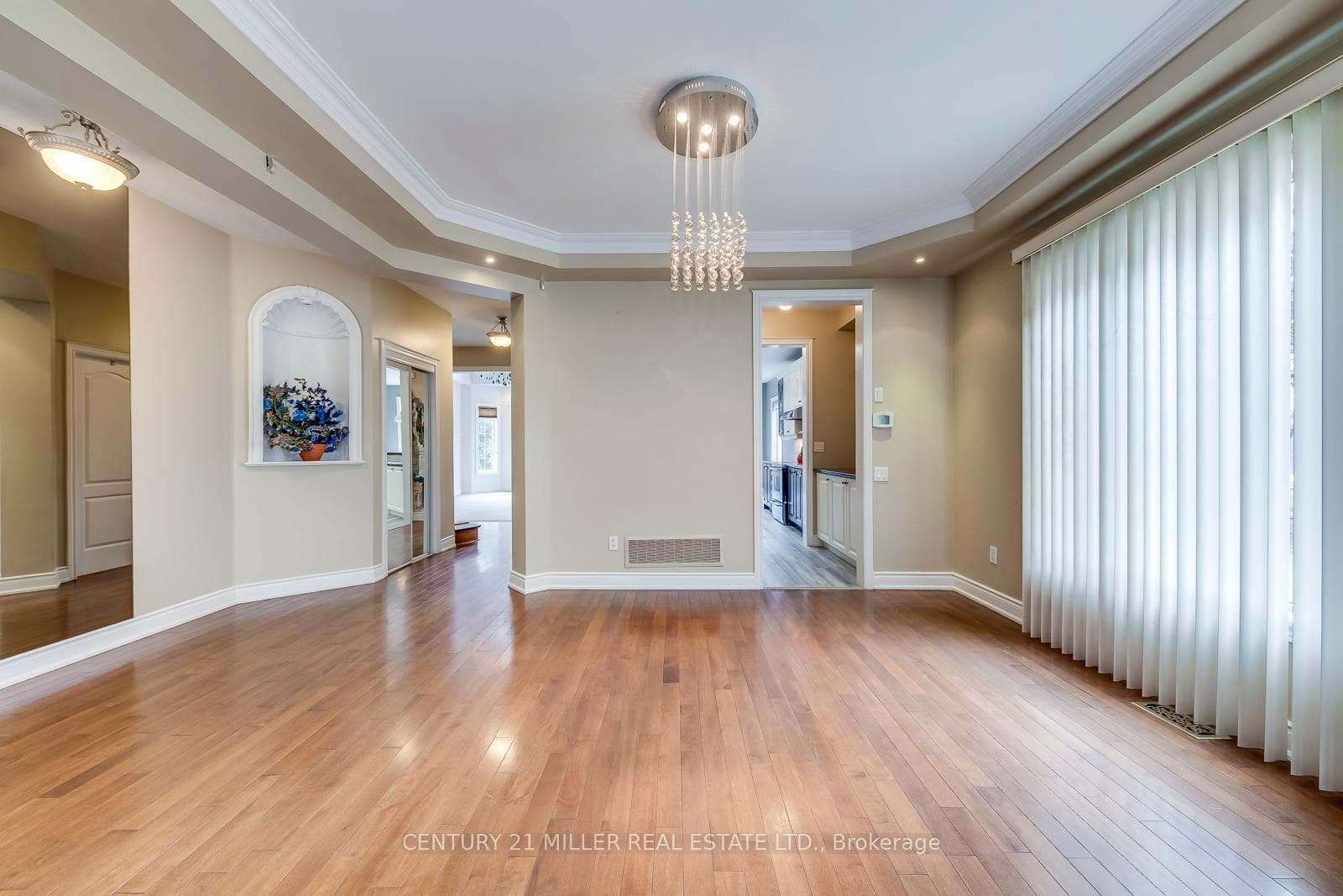 Dining Area With Tray Ceiling & Chandelier
