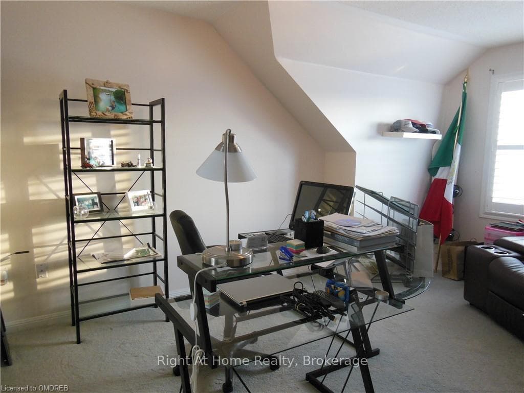 Office space featuring carpet and lofted ceiling