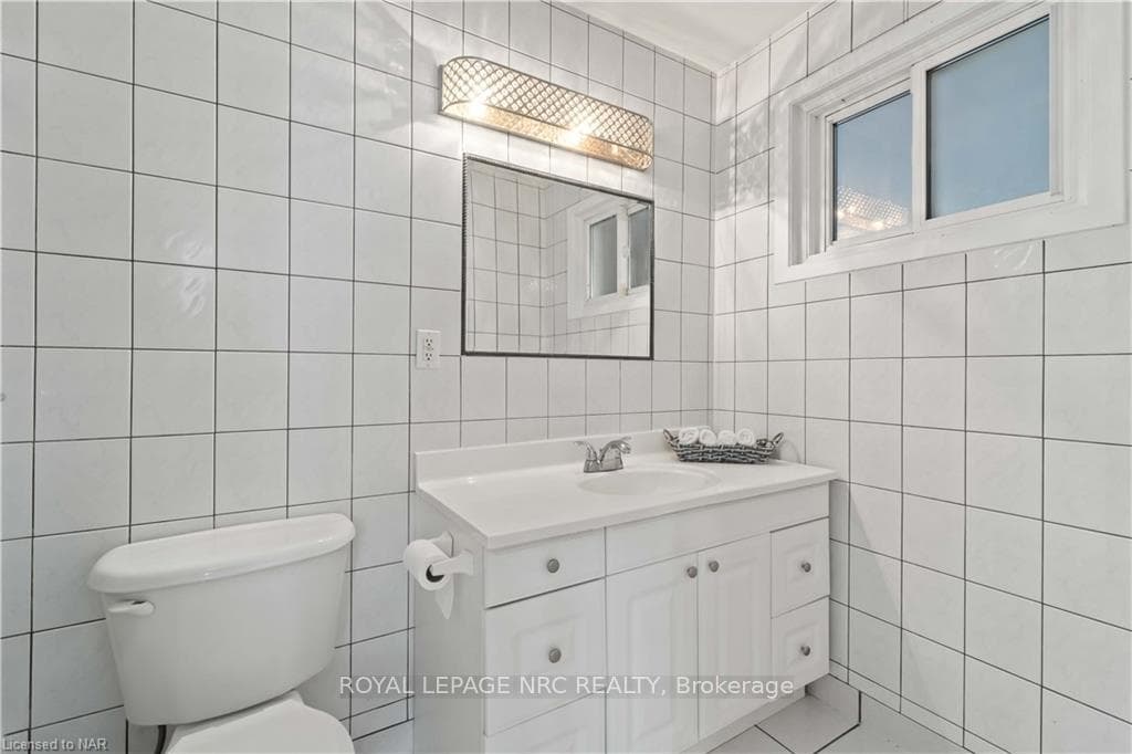 4 pc Bathroom featuring tile walls