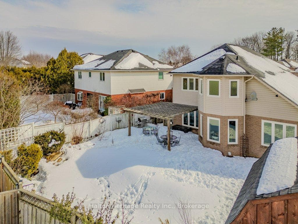Snow Covered Property With Fenced Backyard
