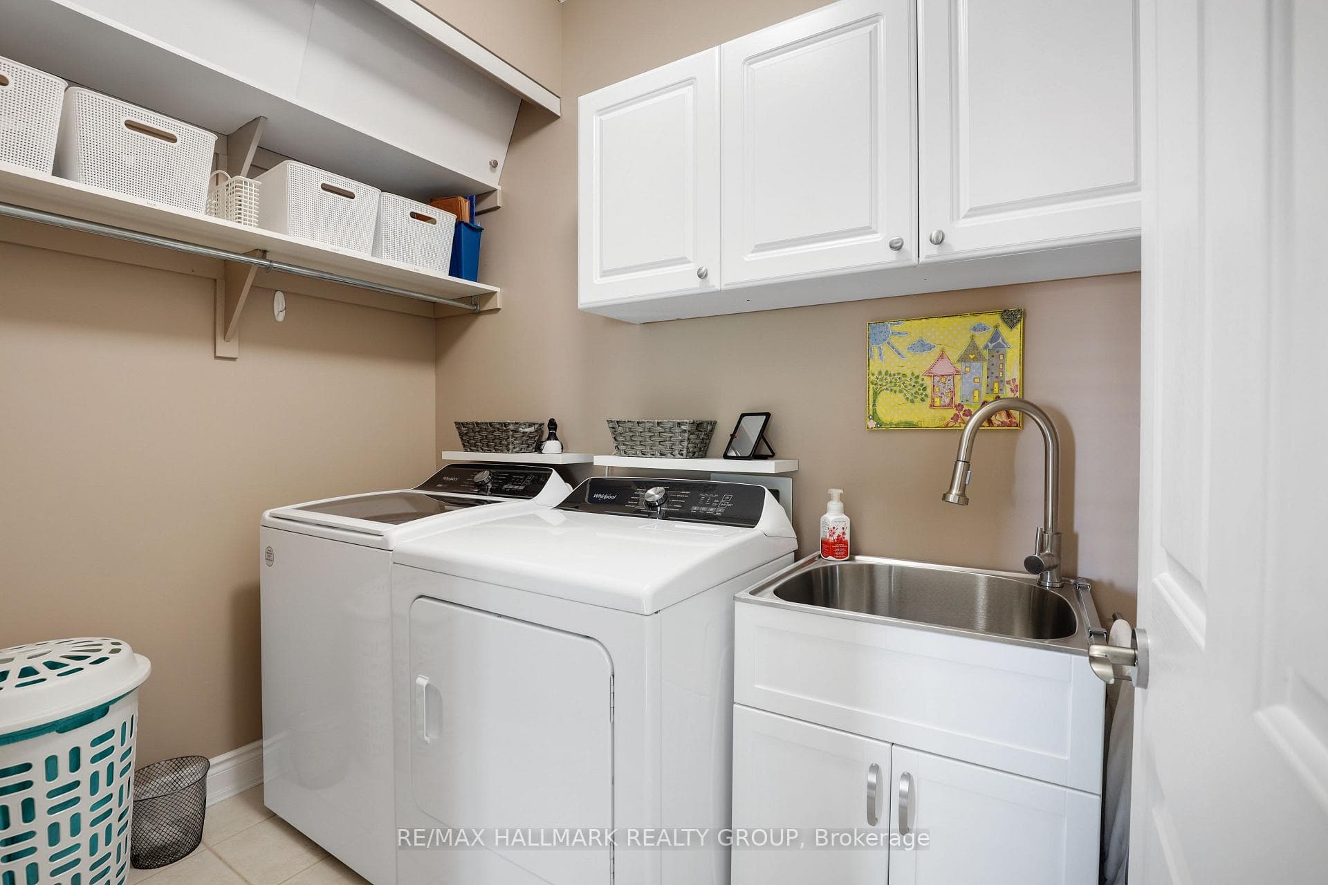 Main floor laundry and storage with laundry sink.