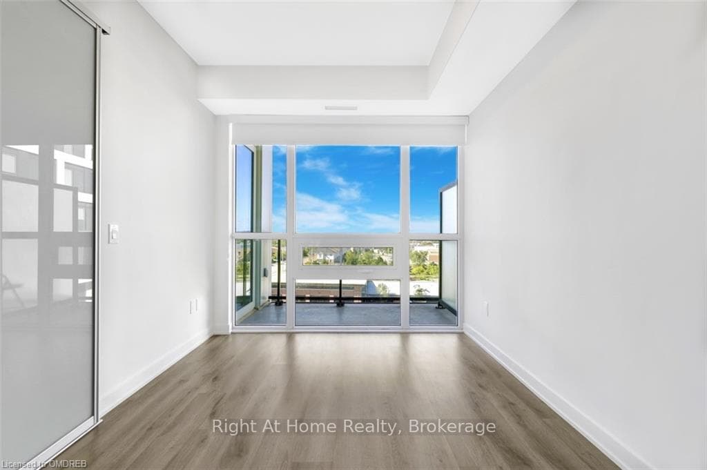 Unfurnished room featuring hardwood / wood-style f