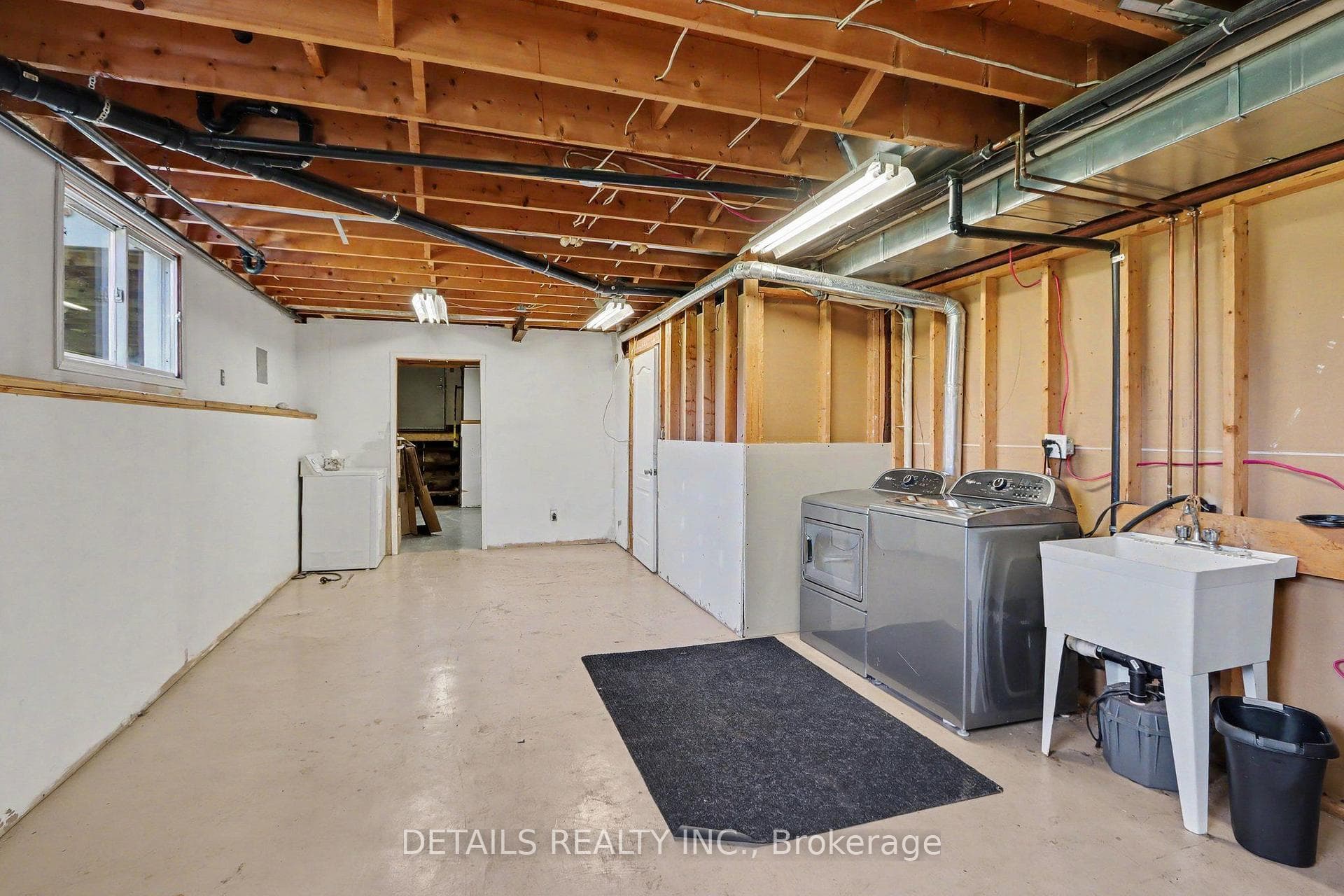 Large laundry/furnace rm with space for craft area