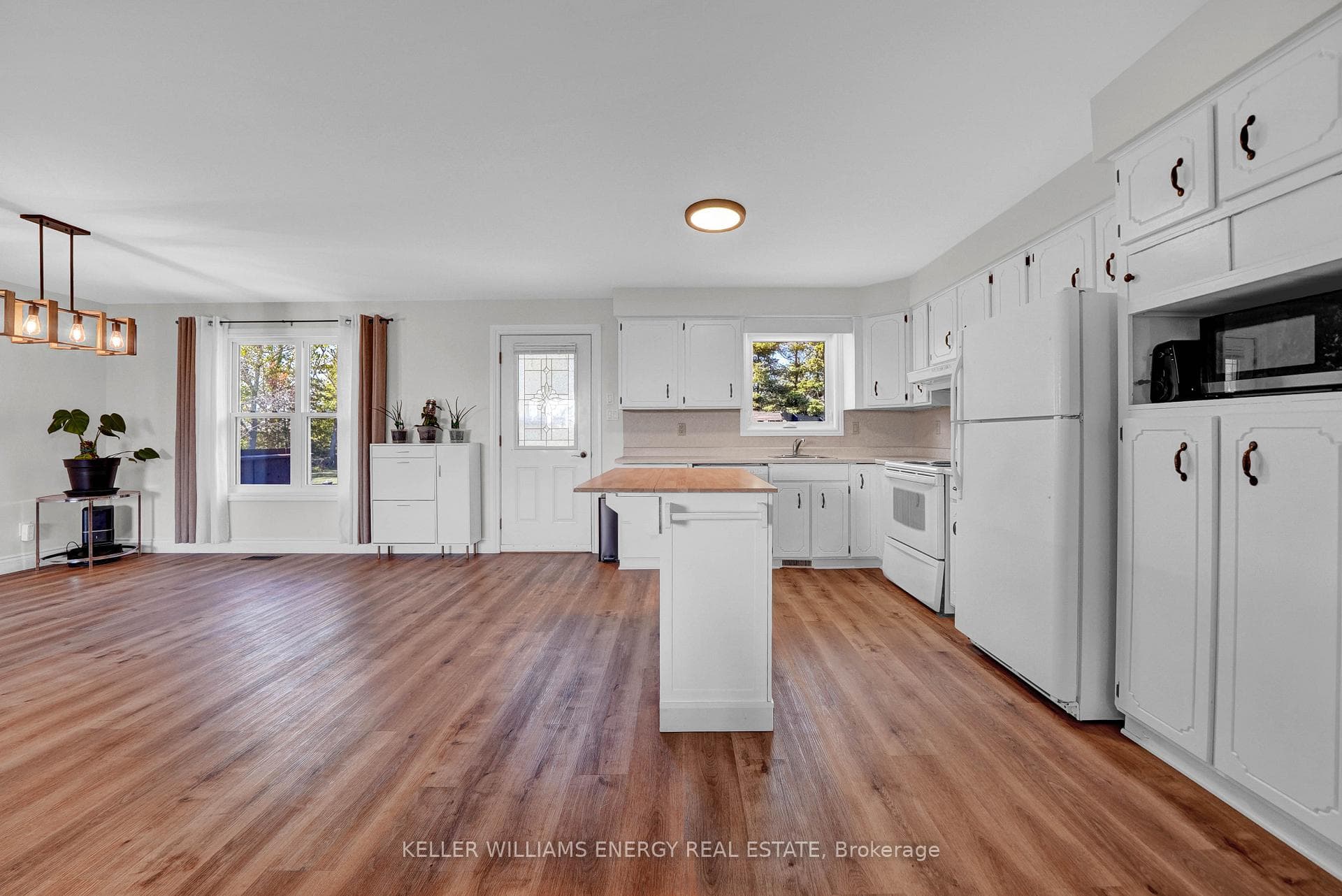 Large kitchen with door to back deck.
