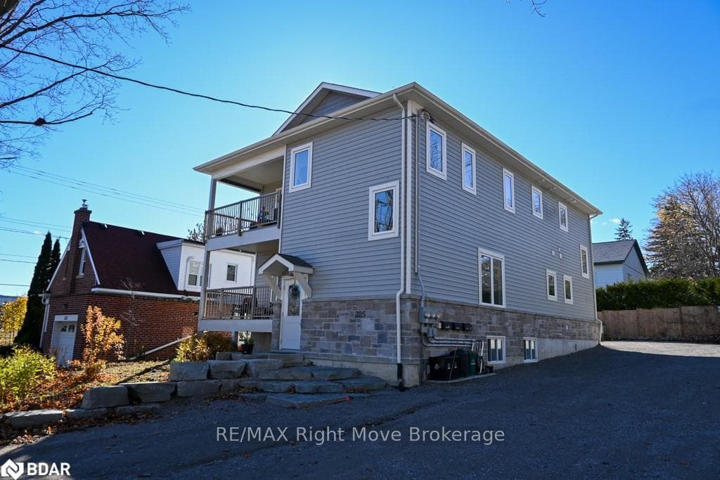 View of side of home featuring a balcony