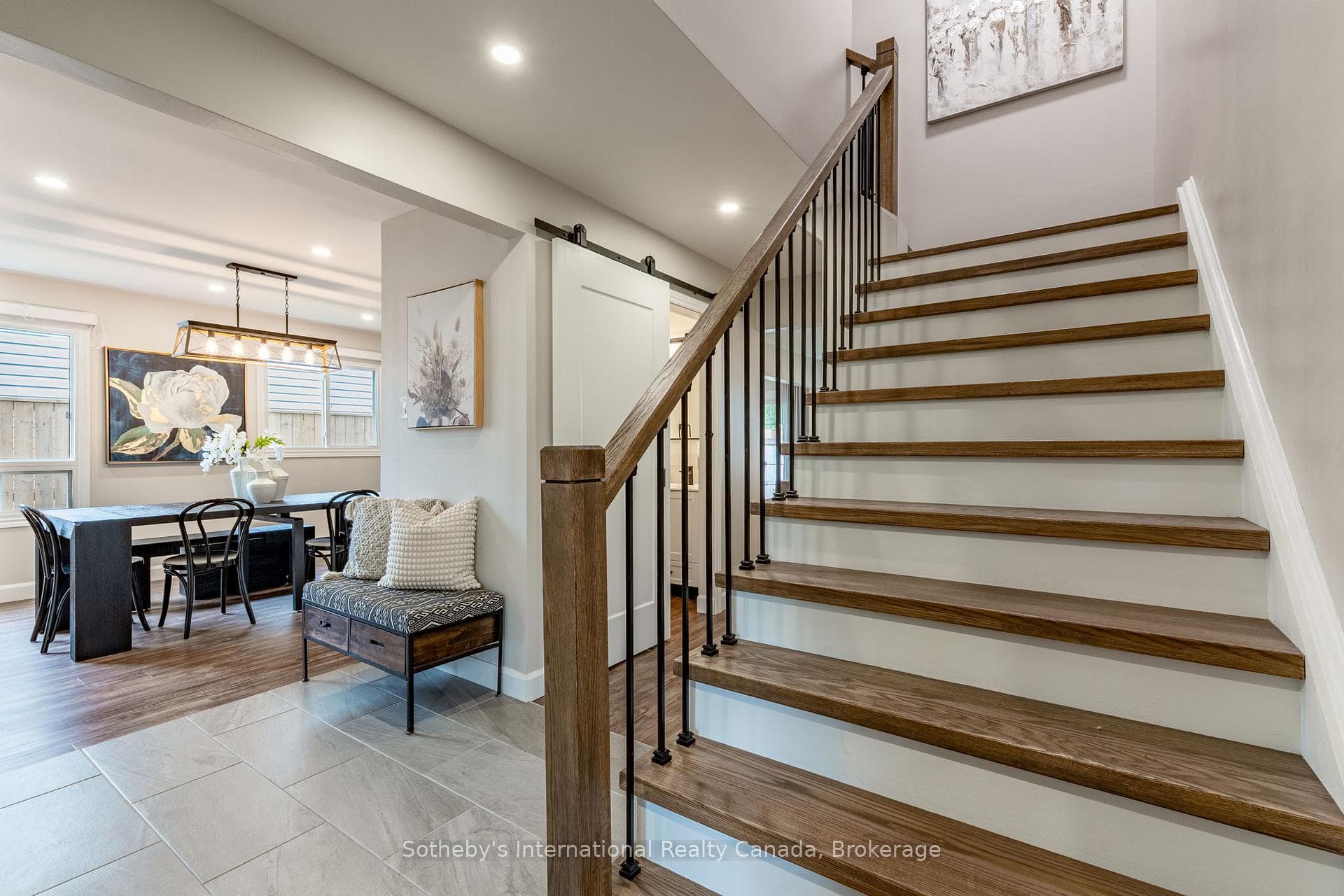Red oak staircase accented by black iron railings.