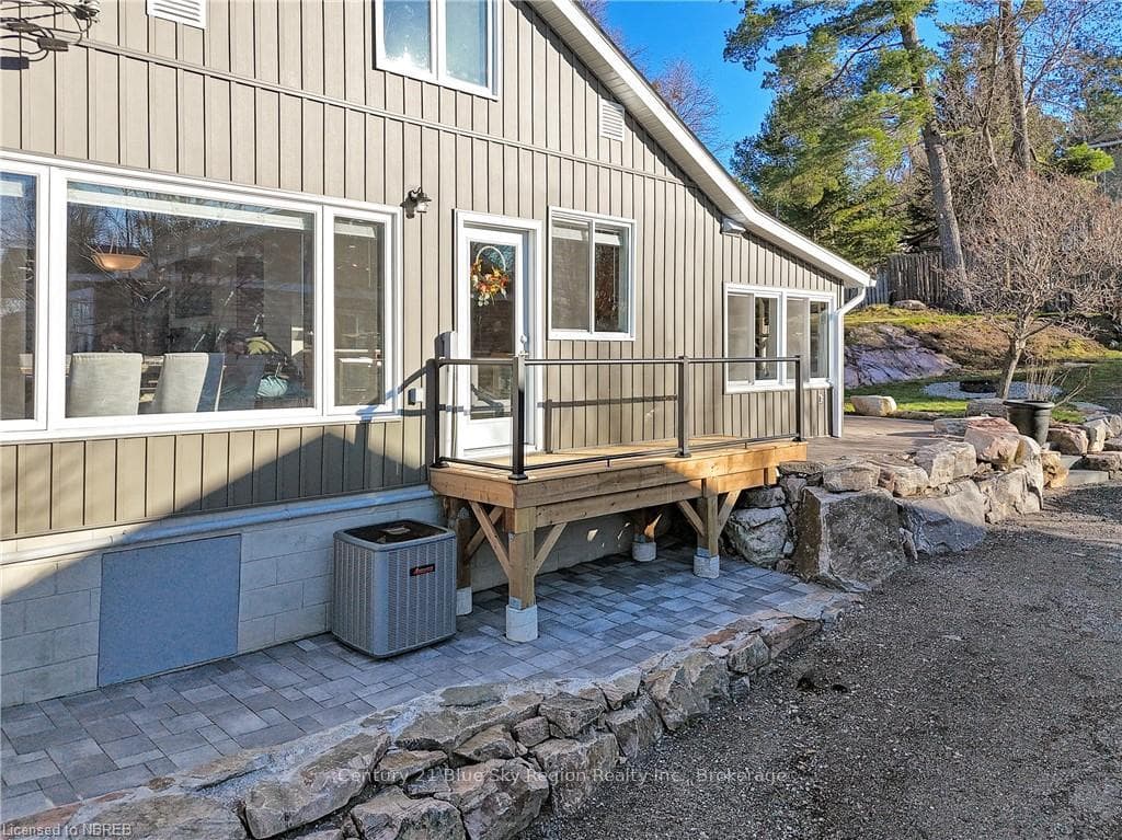 View of exterior entry featuring central AC and a