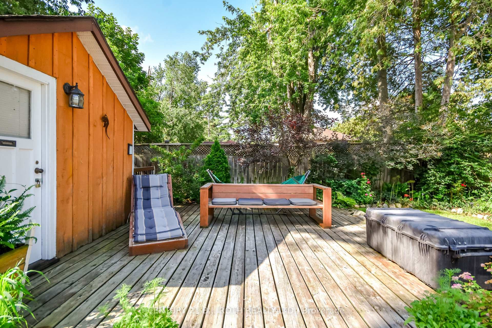 Private backyard deck surrounded by mature trees