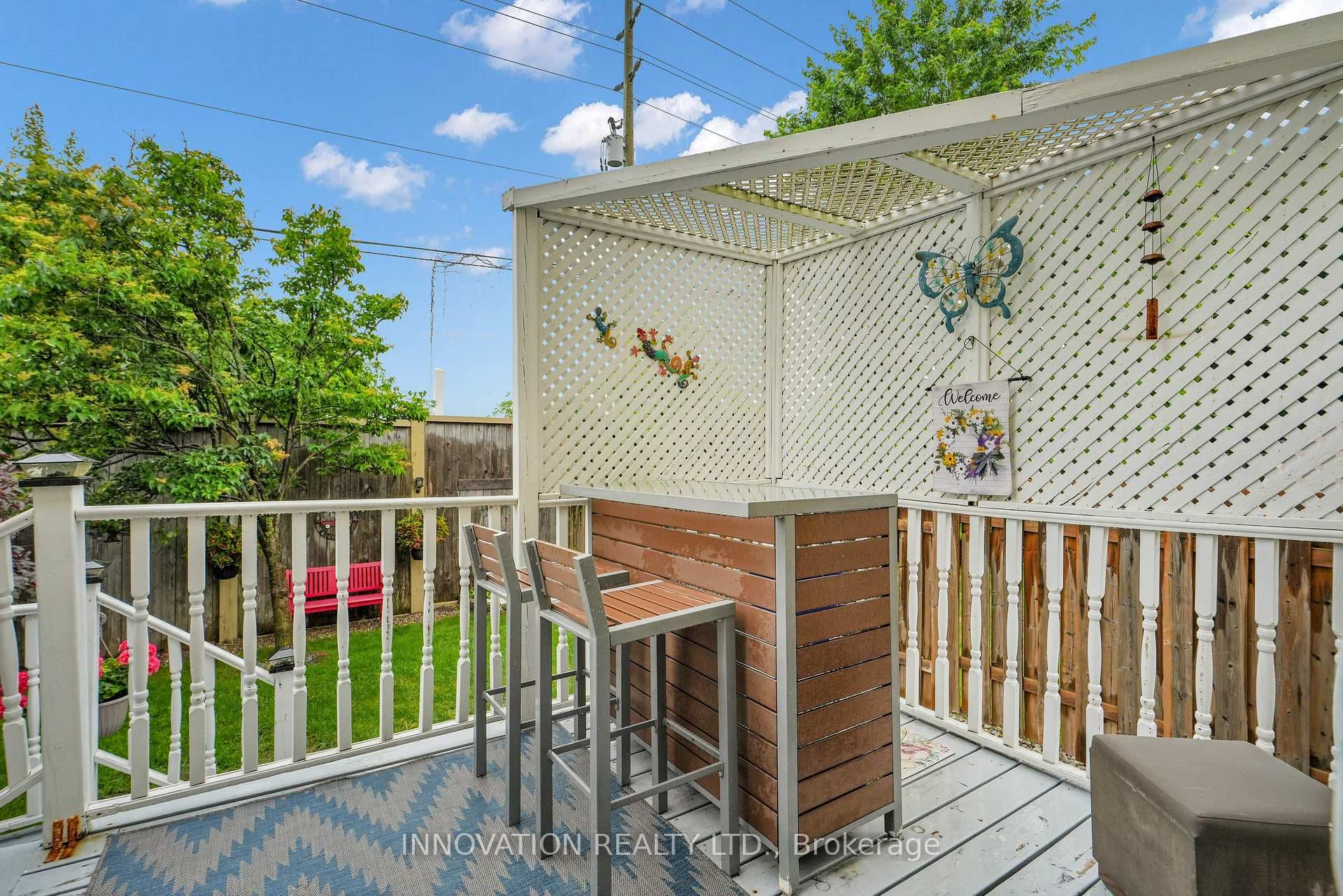 Uppe level deck with privacy screen bar and chairs